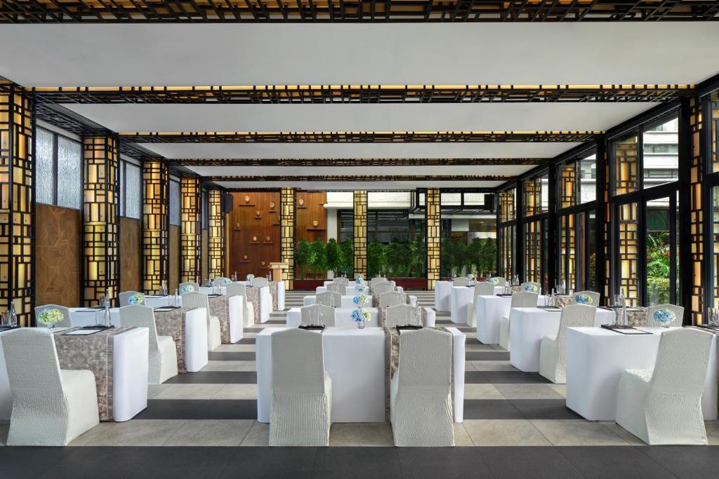 a banquet hall with white tables and chairs at Shangri-La Jakarta in Jakarta