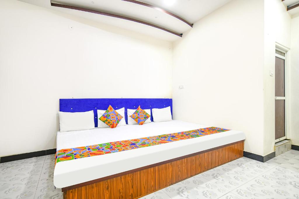 a bedroom with a large bed in a room at FabExpress High Star in Ujjain