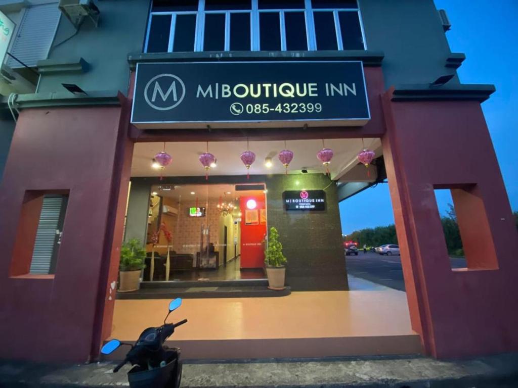 a moped parked in front of a restaurant at M BOUTIQUE INN (PERMYJAYA) in Miri