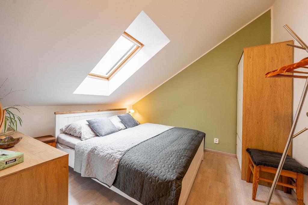 a bedroom with a bed and a skylight at Valentina 2 room flat Hlavná Košice with parking for Fee in Košice