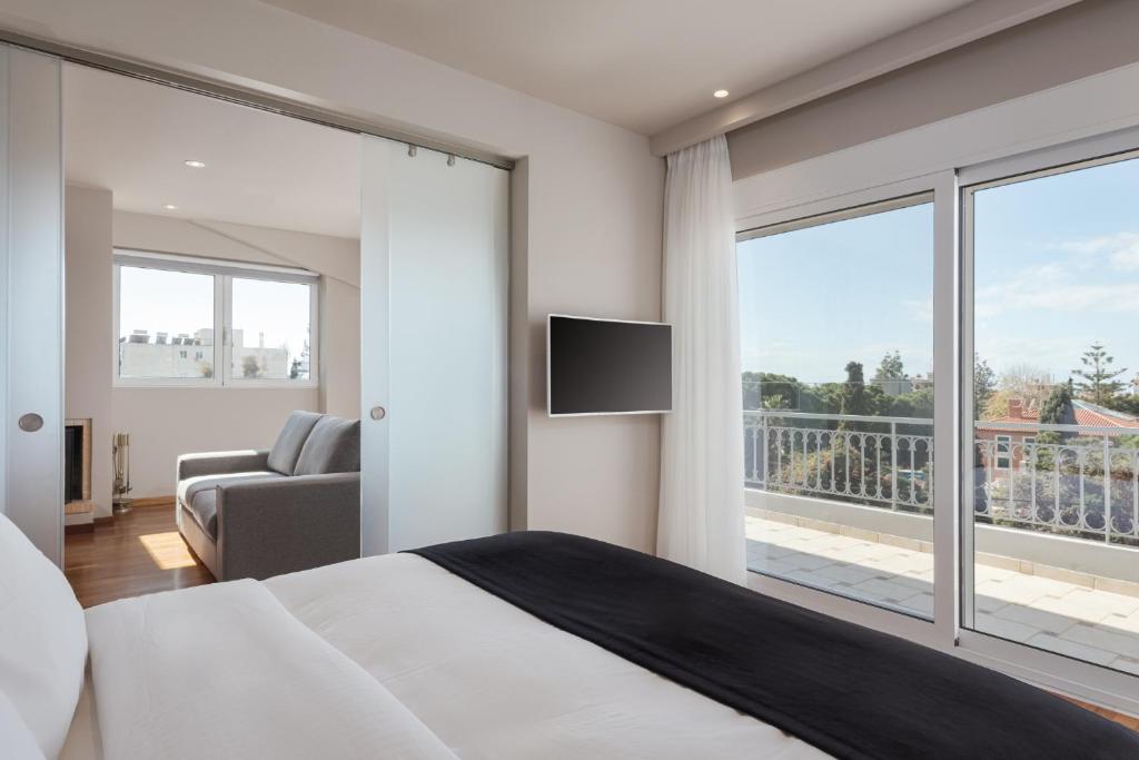 a bedroom with a bed and a large window at Athenian Grand Riviera Villa in Athens