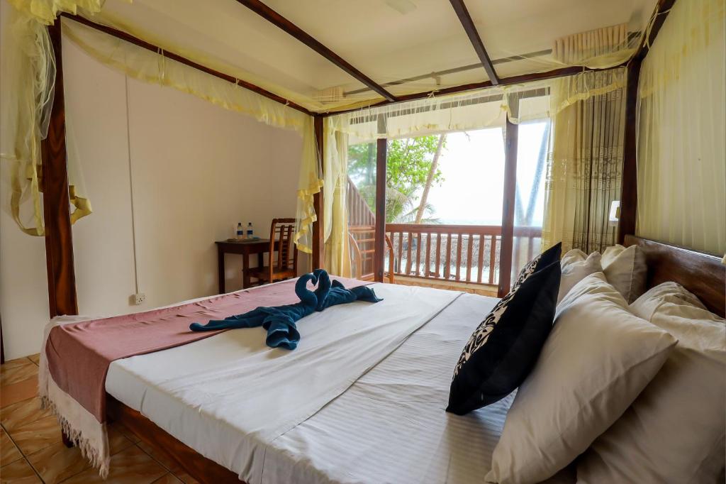 Postel nebo postele na pokoji v ubytování Unawatuna Beach House