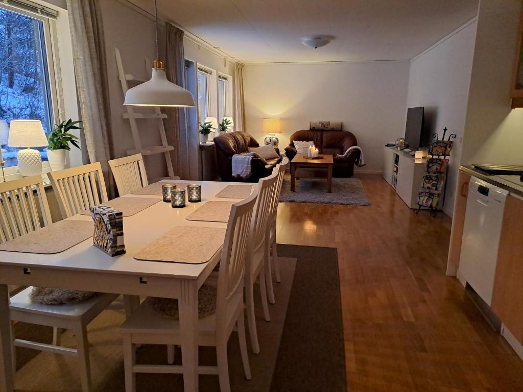 a kitchen and living room with a table and chairs at House in Trångsund, 15 min south of Stockholm, free parking, in Trångsund