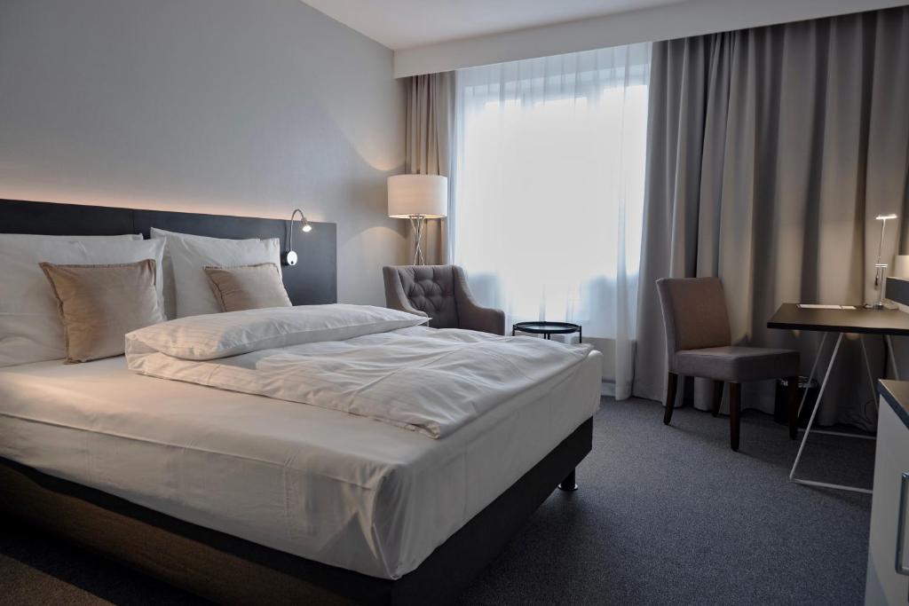 Postel nebo postele na pokoji v ubytování Lindgart Hotel Minden