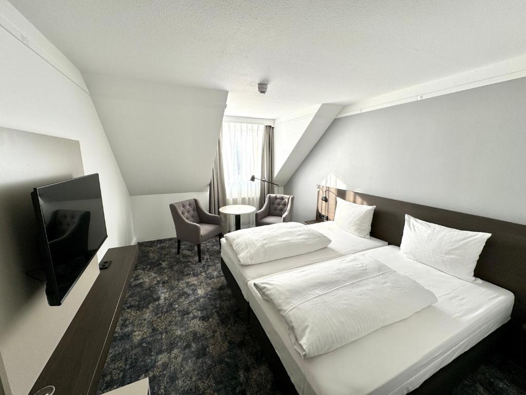Postel nebo postele na pokoji v ubytování Lindgart Hotel Minden