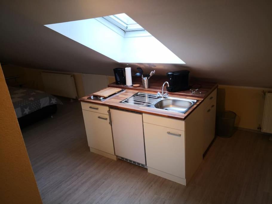 a small kitchen with a sink and a skylight at Über den Dächern von Mörfelden-Walldorf in Mörfelden-Walldorf
