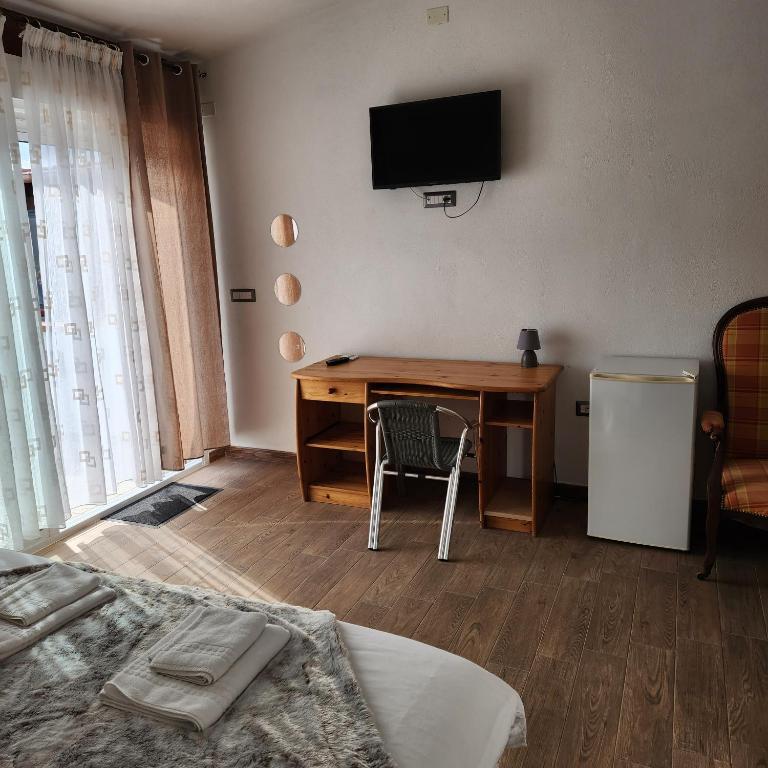 TV a/nebo společenská místnost v ubytování Iloghe di Marras