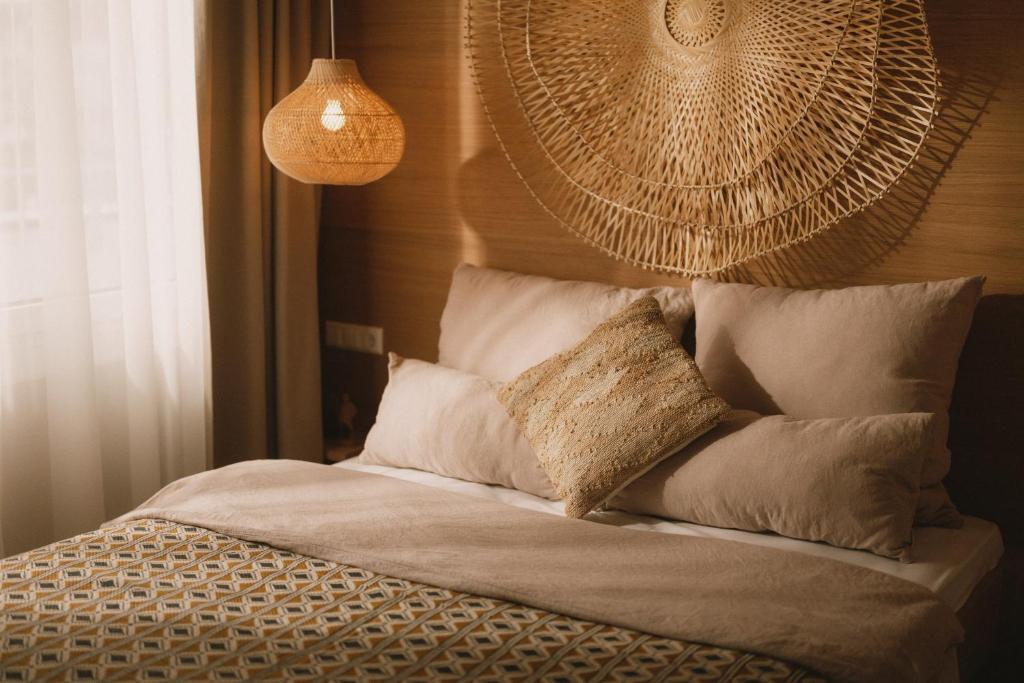 a bed with white sheets and pillows in a room at 2Places Soul in Lörrach