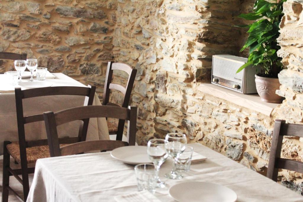 a restaurant with tables and chairs with wine glasses at Borgo del Canto in Borghetto dʼArroscia