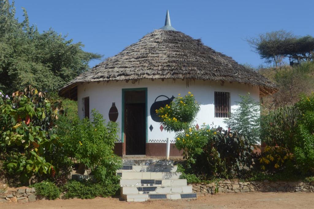 a small house with a thatched roof at Holale Hotel in Moyale