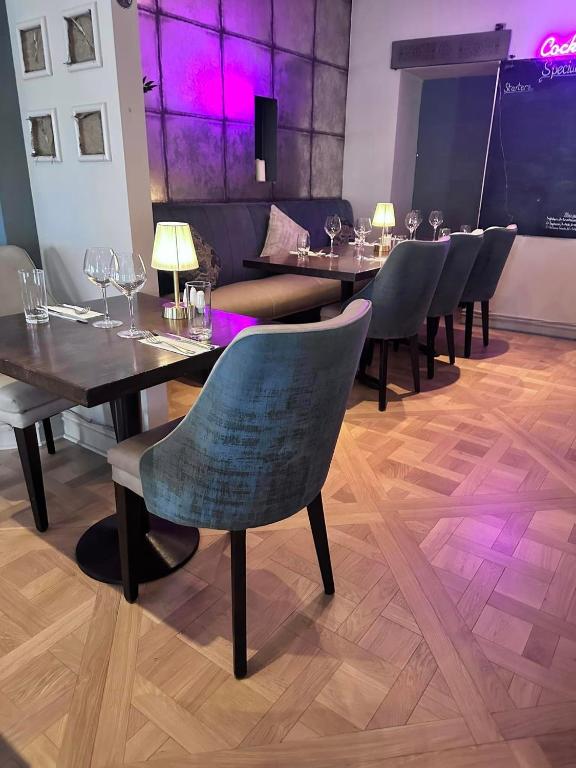a dining room with tables and chairs with wine glasses at Headfort Arms Hotel in Kells