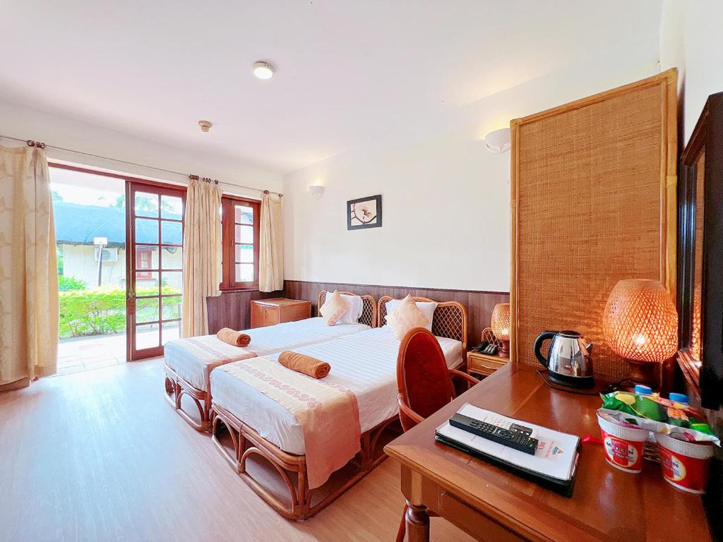 Giường trong phòng chung tại Little Muine Cottages Resort