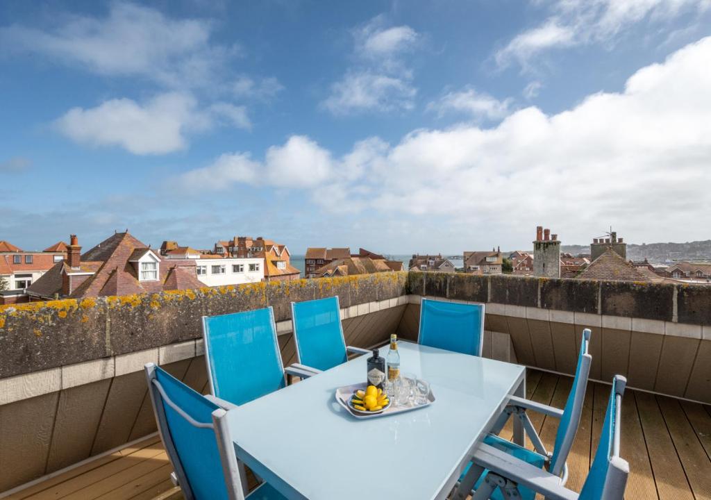 a table and chairs on a balcony with a view at Flat 9 Broadleys in Swanage