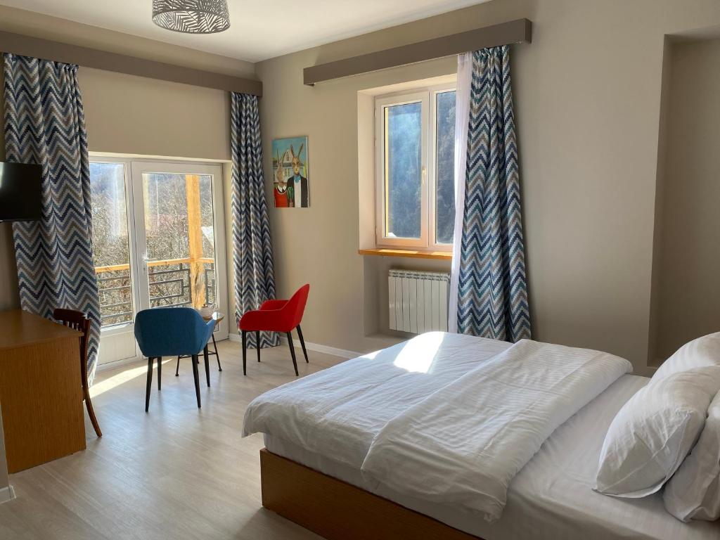 a bedroom with a bed and a table and chairs at RestArt Boutique Hotel in Dilijan