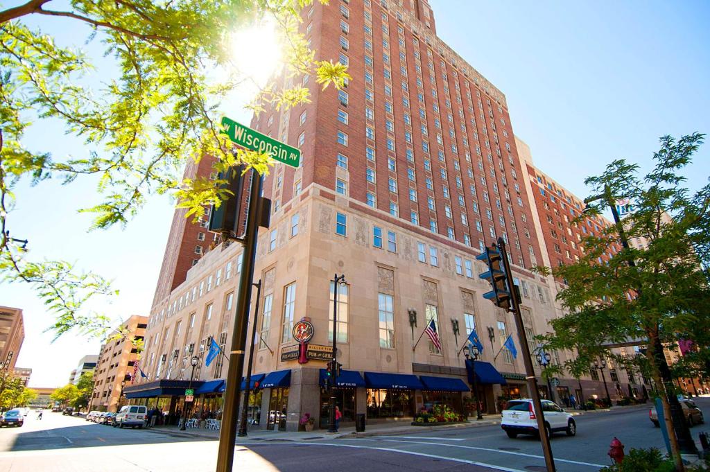 a street sign in front of a large building at Hilton Milwaukee City Center in Milwaukee