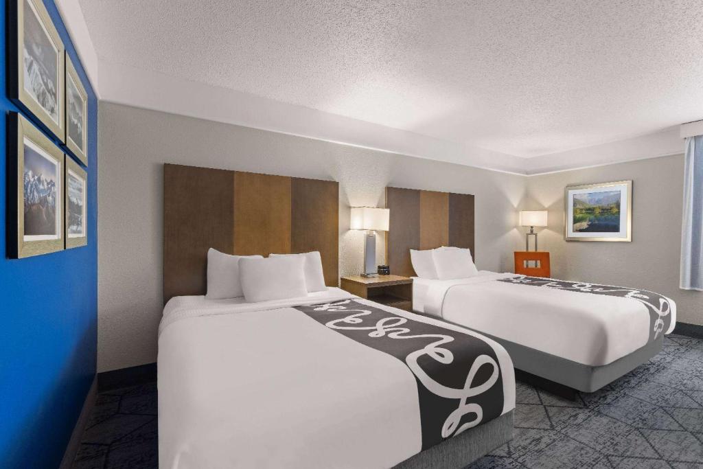 a hotel room with two beds in a room at La Quinta Inn and Suites by Wyndham at WaTiki Waterpark in Rapid City