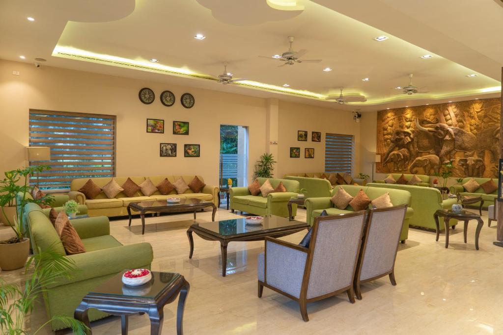 a large living room with couches and tables at Resort De Coracao - Corbett , Uttarakhand in Rāmnagar