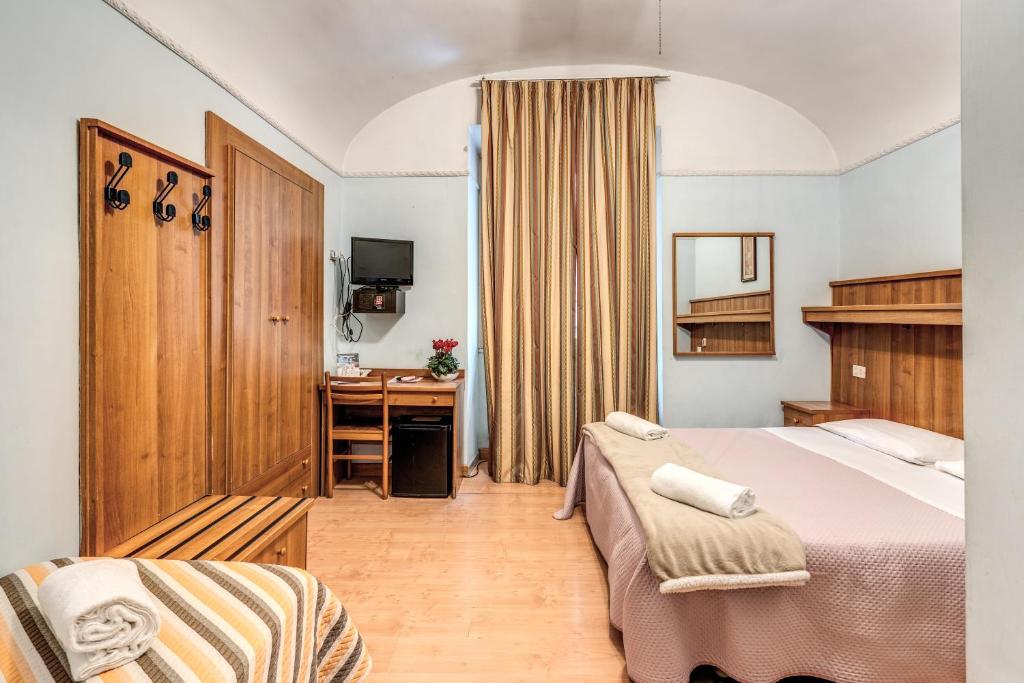 a bedroom with a bed and a desk in it at Hotel Altavilla in Rome