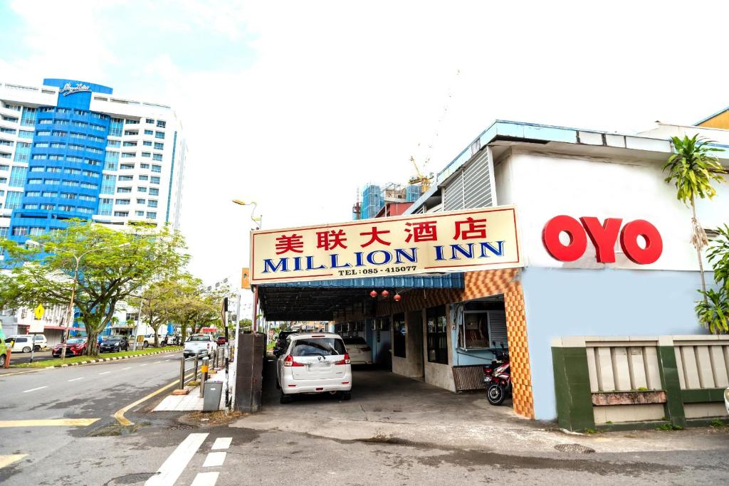 a car is parked in front of a million inn at OYO 90208 Milion Inn in Miri