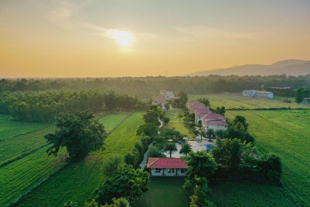 an aerial view of a house in a field at Resort De Coracao - Corbett , Uttarakhand in Rāmnagar