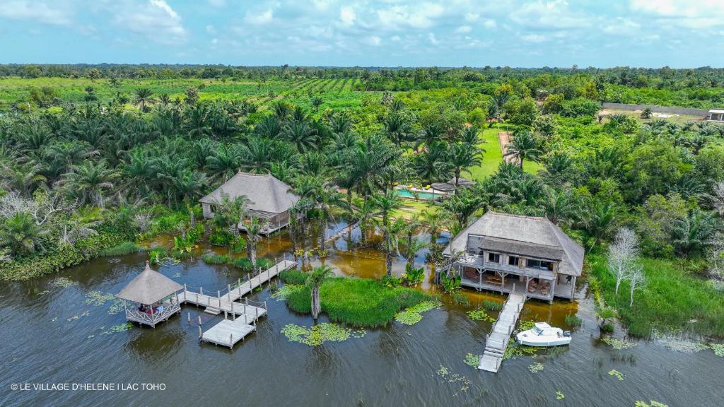 an aerial view of a house in the water at LE VILLAGE D'HÉLÈNE - Natura Resort in Ouidah