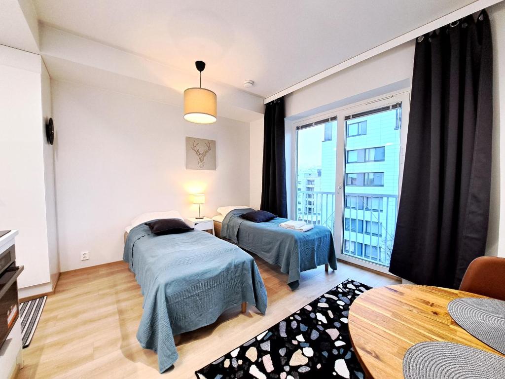 Säng eller sängar i ett rum på Kotimaailma Apartments - Moderni ydinkeskustan yksiö - Aleksanterinkatu