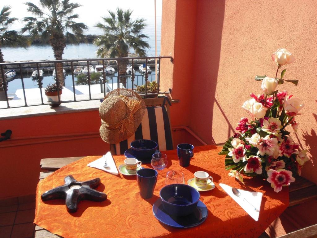 a table with food and a view of the water at Cà de Matagè in Riva Ligure