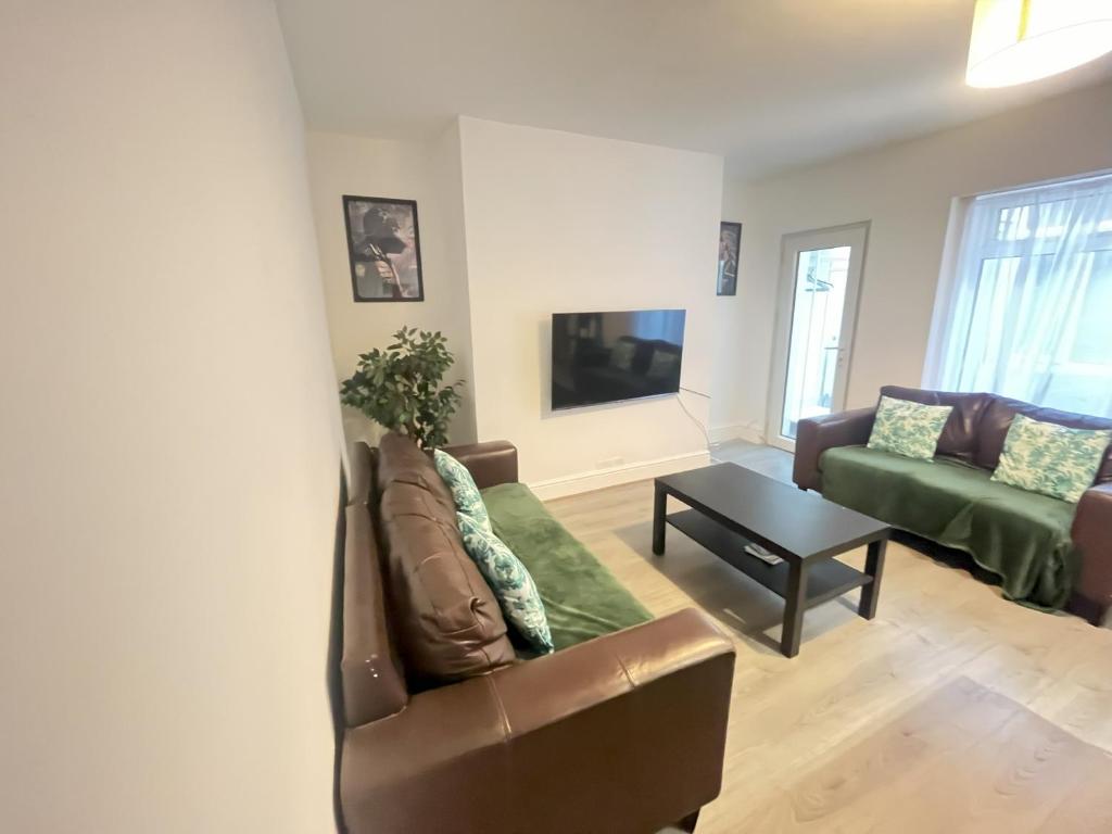 a living room with a couch and a table at lovely place near to beach in Brighton & Hove