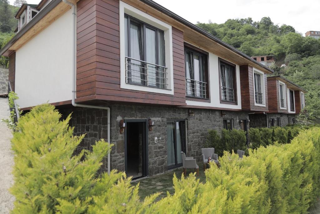 a house with windows on the side of it at STONE VILLAGE in Trabzon