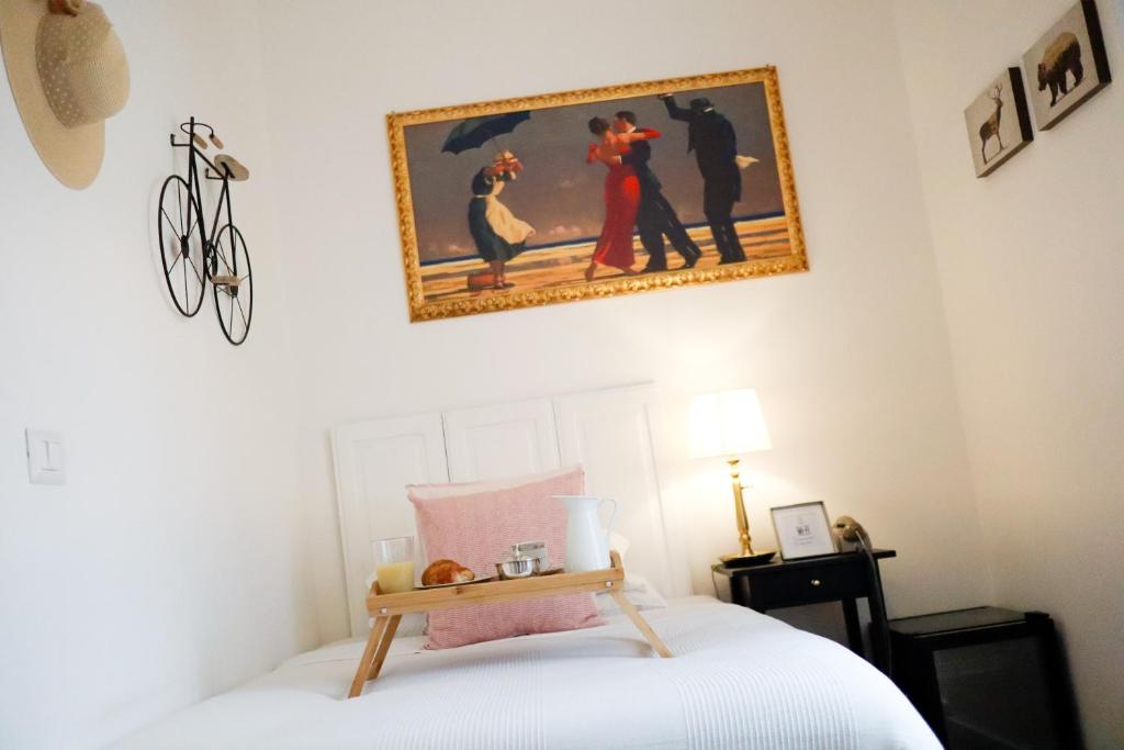 a bedroom with a bed with a picture on the wall at Guest House Camilla in Alghero