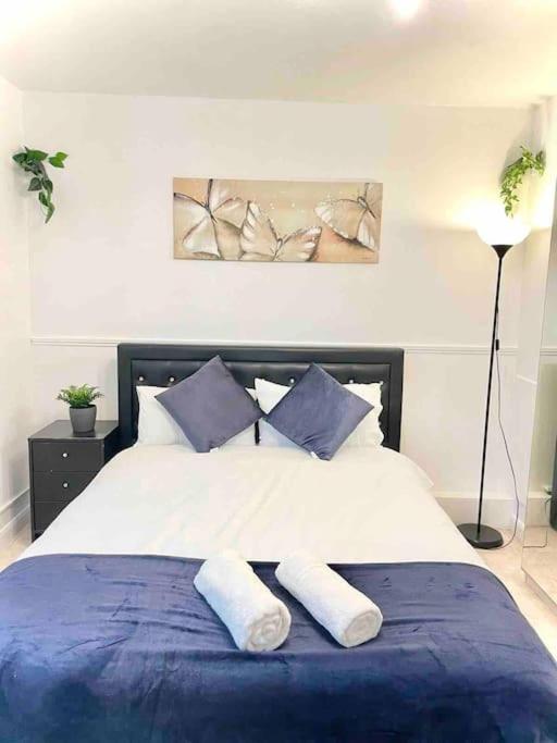 a bedroom with a large bed with two pillows at Great Studio flat in Central London in London