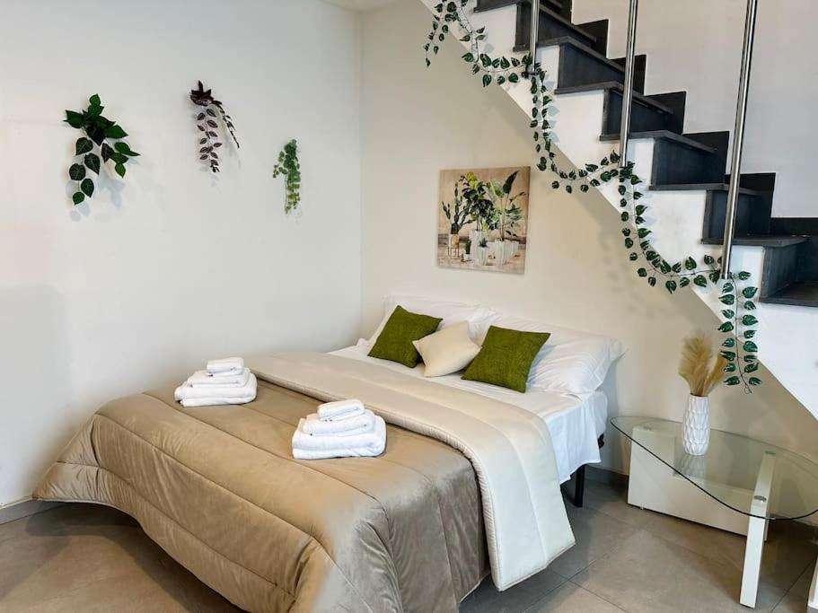a bedroom with two beds and a glass table at Lucrezia’s home A in Catania