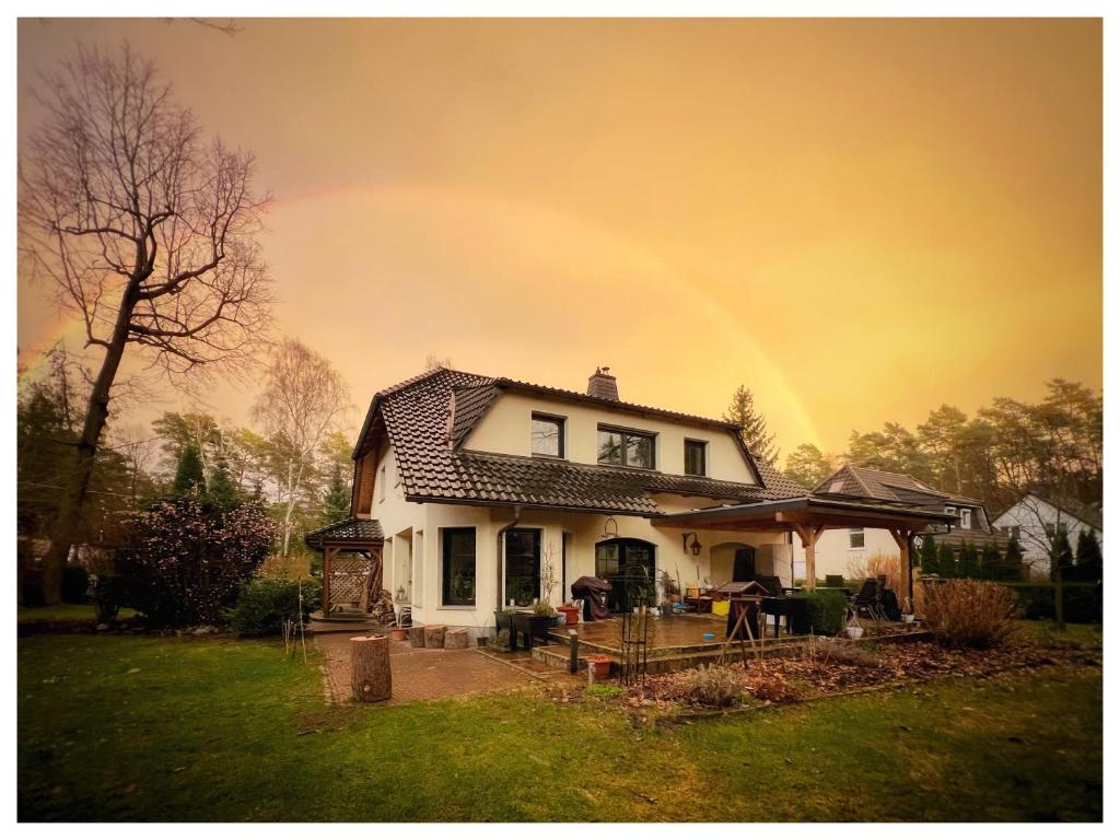 a rainbow in the sky above a house at The House Stiller Grund in Hohenfließ