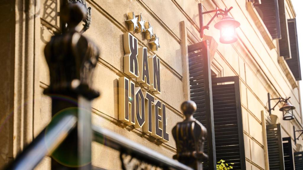 a building with a sign on the side of it at Xan Hotel in Baku