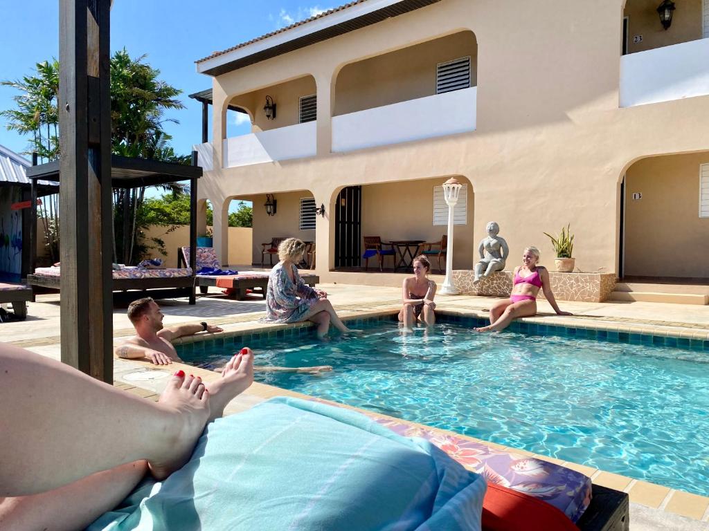 een groep mensen die in een zwembad zitten bij Casa Amalia in Willemstad