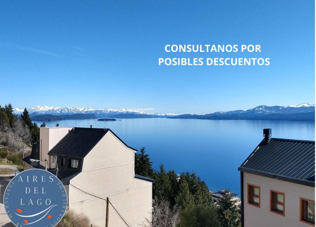 a view of a body of water with a building at Aires del Lago in San Carlos de Bariloche