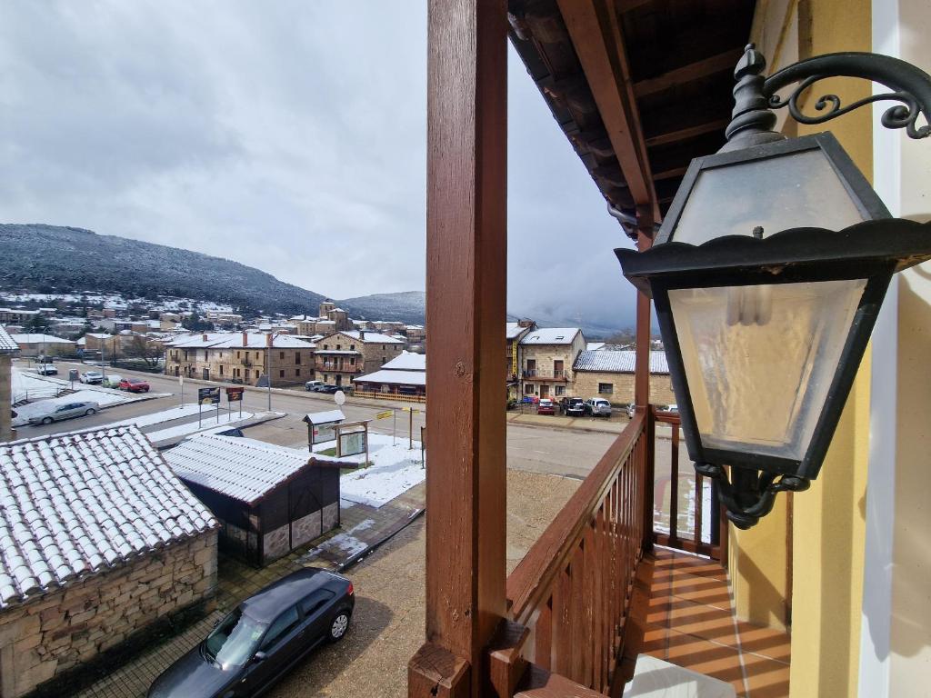 a balcony with a lamp and a view of a city at Hotel Virginia R.H. in Vinuesa