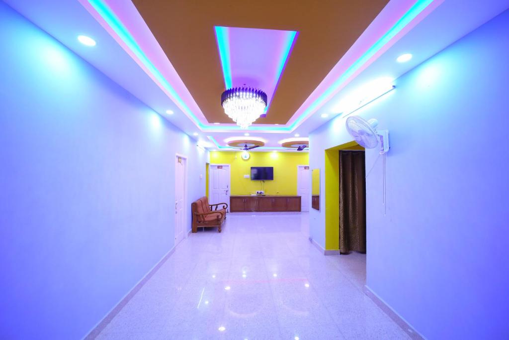 a hallway with a blue light on the ceiling at DayLight Stay in Chennai