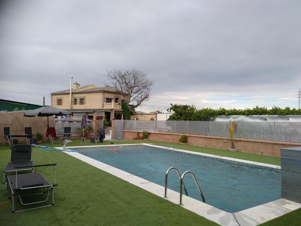 a swimming pool in the backyard of a house at Rural Villa Garcia Molina Baza in Baza