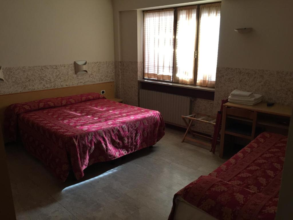 Letto o letti in una camera di Hotel Nettuno