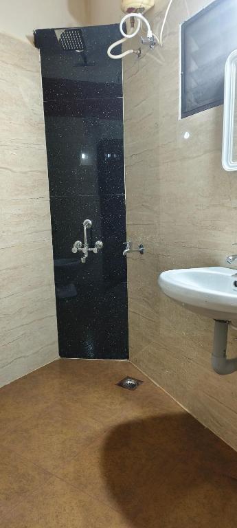 a bathroom with a sink and a shower at Prakruthi home 2 in Mangalore
