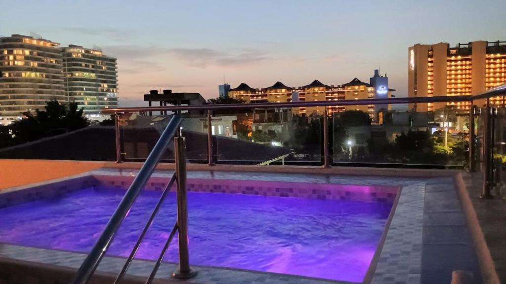 a swimming pool on the roof of a building at Encanto Apartahotel in Santa Marta