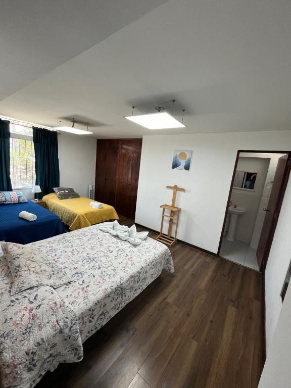 Ένα ή περισσότερα κρεβάτια σε δωμάτιο στο Harmony Inn Miraflores
