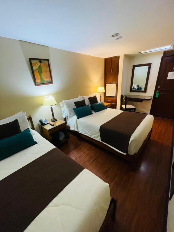 Postel nebo postele na pokoji v ubytování Hotel La Sabana