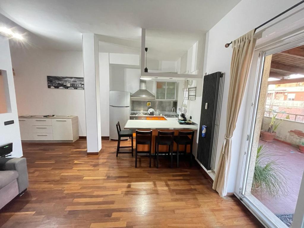 a kitchen and dining room with a table and chairs at Le Palme in Lido di Ostia