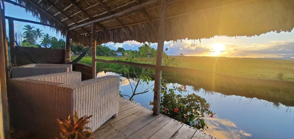 a house with a view of a river and the sunset at Mini Lodge in Cabarete