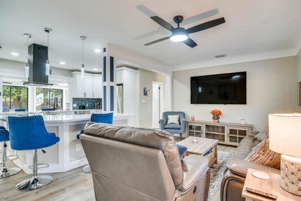 a living room with a couch and a ceiling fan at Serene St Petersburg Home with Private Hot Tub in St Petersburg