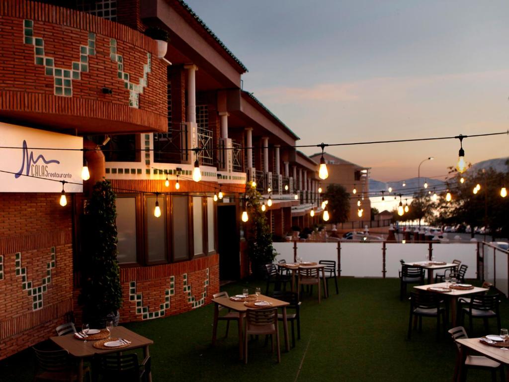 a restaurant with tables and chairs on a patio at Hotel Boutique Calas de Alicante in Alicante