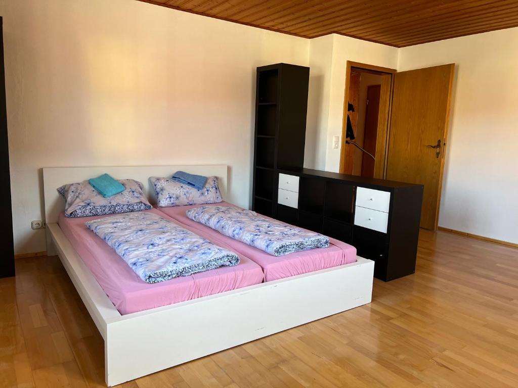 a bedroom with a bed with a white frame and purple sheets at Ferienplatzl 90m2 in Peißenberg