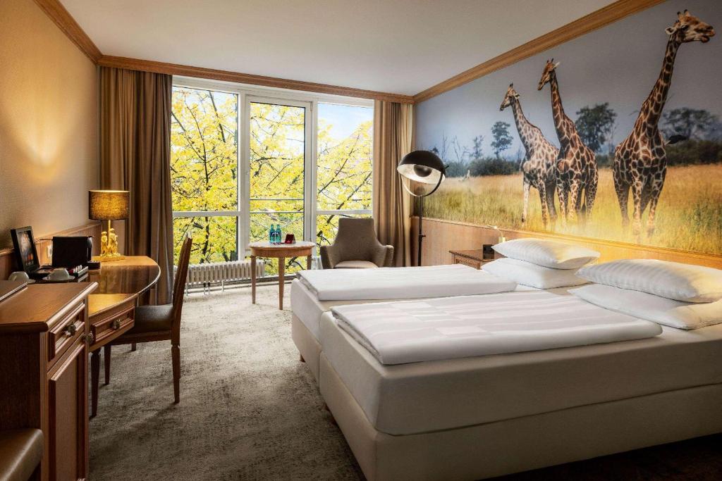 Postel nebo postele na pokoji v ubytování Amedia Hotel & Suites Leipzig, Trademark Collection by Wyndham